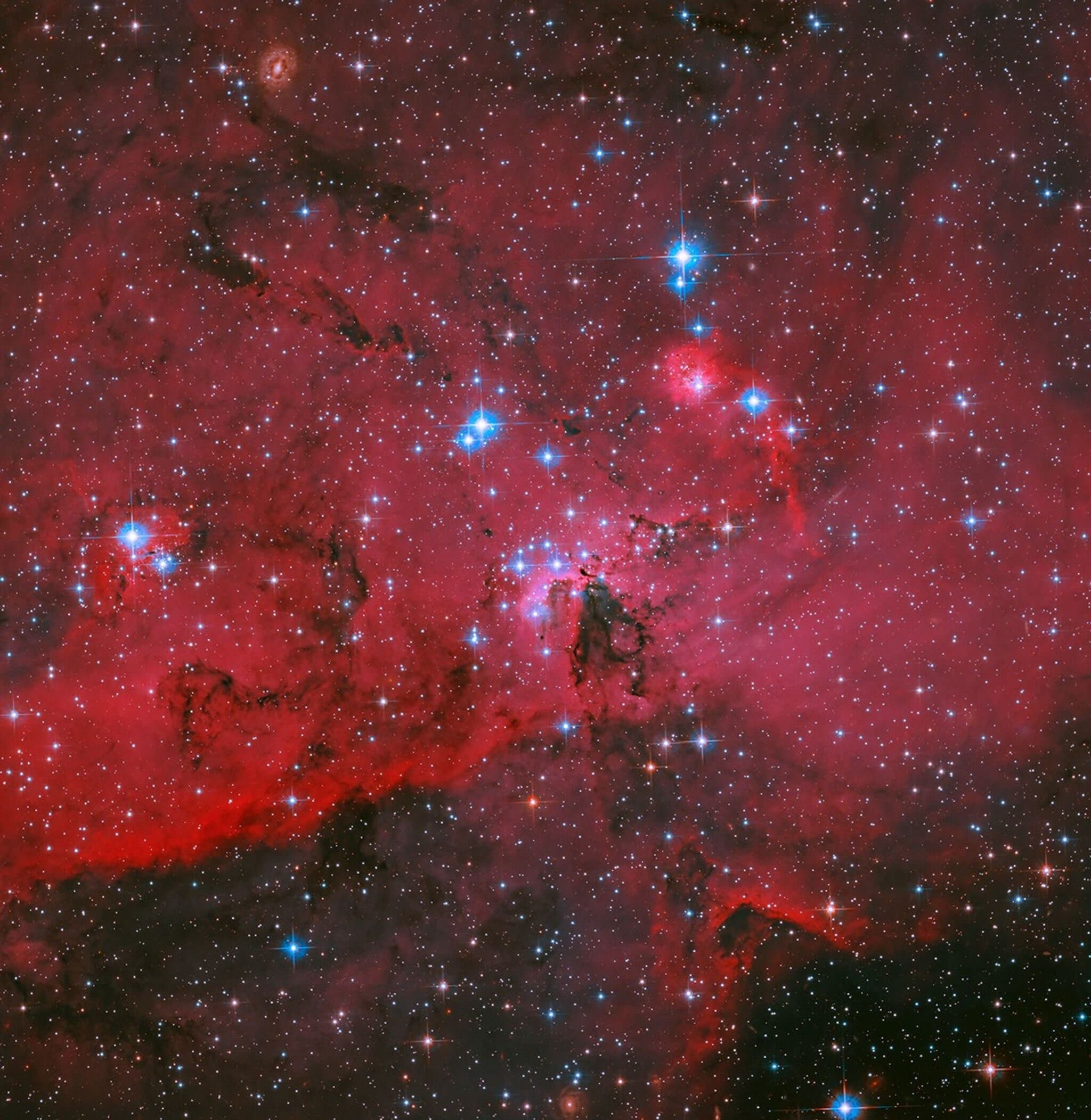 Photo: Hubble sees crimson cloud and stars